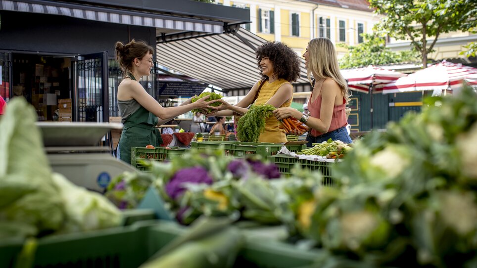 Zwei Frauen kaufen frisches Gemüse auf dem Kaiser Josef Markt in Graz. | © Graz Tourismus - Tom Lamm