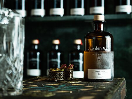 Bottle of Van den Berg London Dry Gin on a table next to a glass. | © EX KARELLY PHOTOGRAPHY