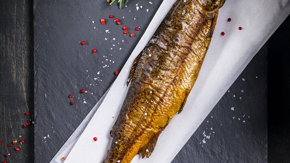 Grilled fish on a black stone with spices. | © Werner Krug