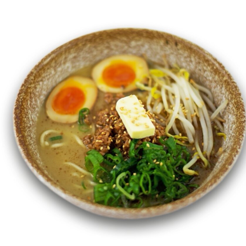 Bowl of Hokkaido ramen with soft-boiled eggs, vegetables, and toppings. | © Ichi-Go Ichi-E