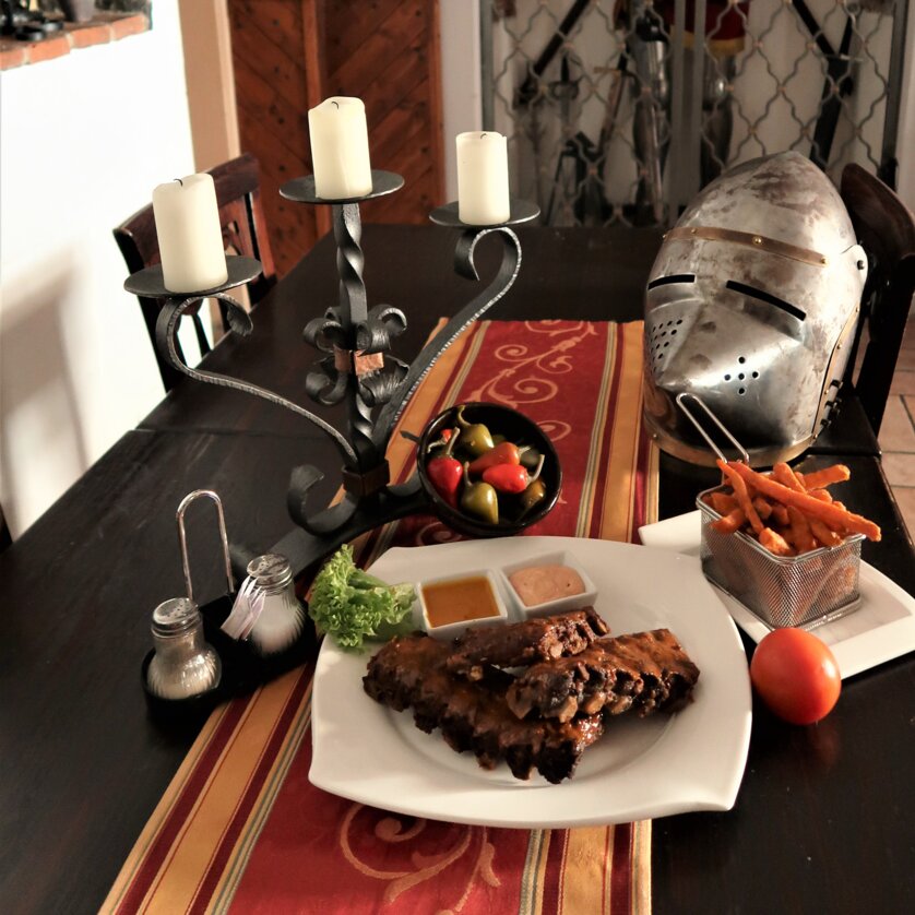 Table with hearty food in a rustic restaurant.