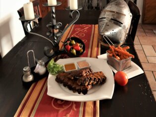 Table with hearty food in a rustic restaurant.