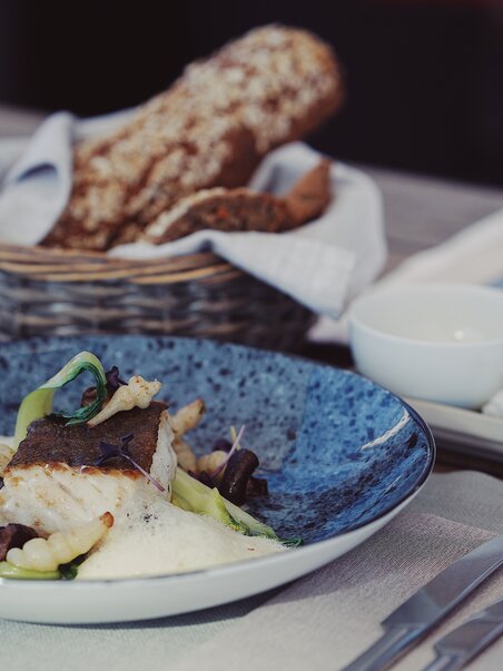 An artistically arranged fish dish with sides. | © aiola