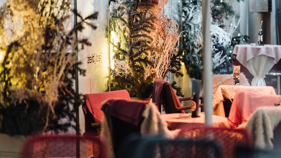 Caffè accogliente con decorazioni festive e piante. | © Ripix