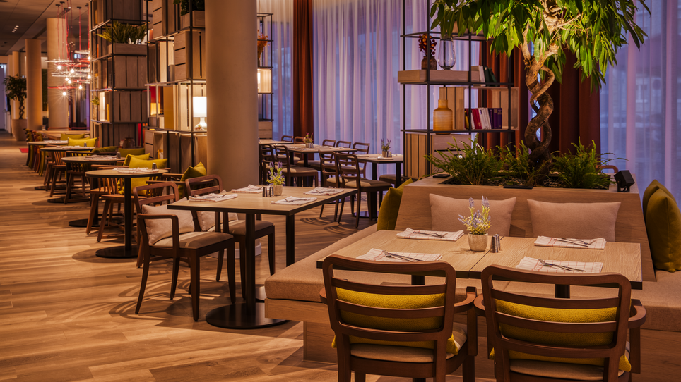Modern restaurant in IntercityHotel Graz featuring wooden floors and plants. | © IntercityHotel Graz