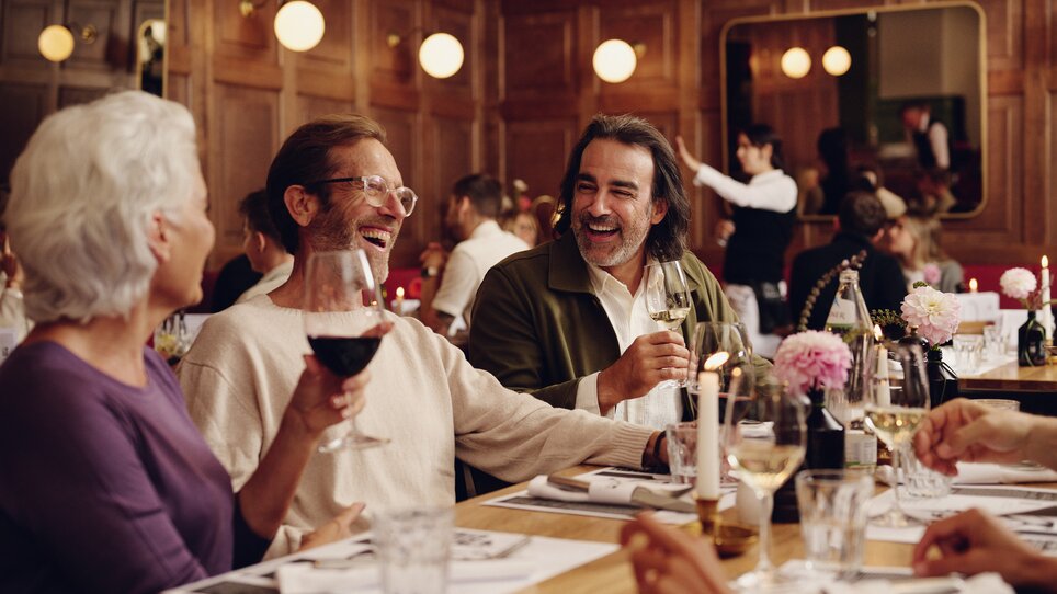 Friends enjoying time dining in a restaurant. | © Florian Weitzer Hotels und Restaurants