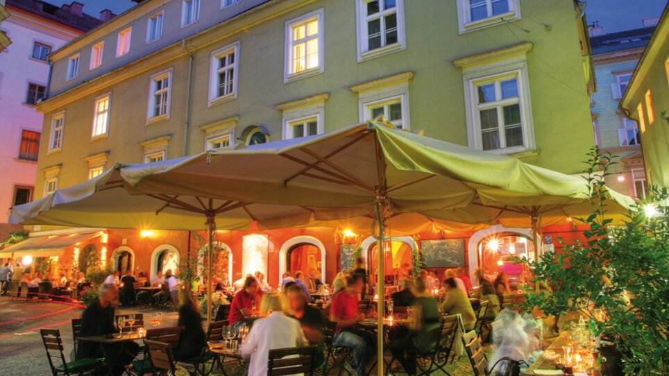 Cozy restaurant with illuminated tables in Graz. | © Don Camillo