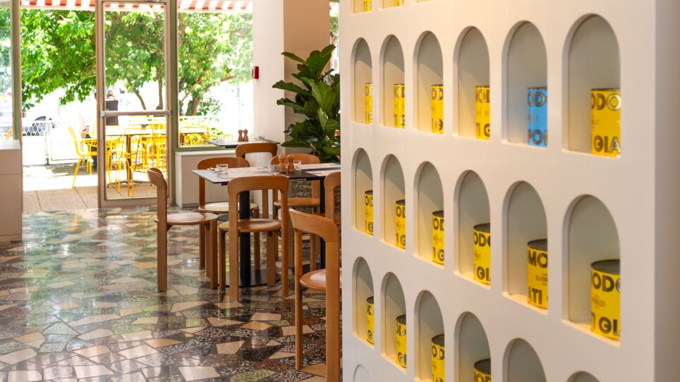 Modern interior design featuring colorful cans on shelves. | © Florian Weitzer Hotels & Restaurants