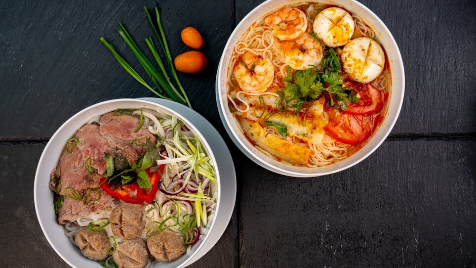 Two bowls of noodle soups, one with meatballs and the other with shrimp. | © Ma Kitchen