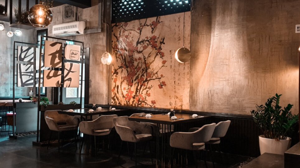 Stylish Asia Restaurant Sakana with patterned wall and modern furniture.
