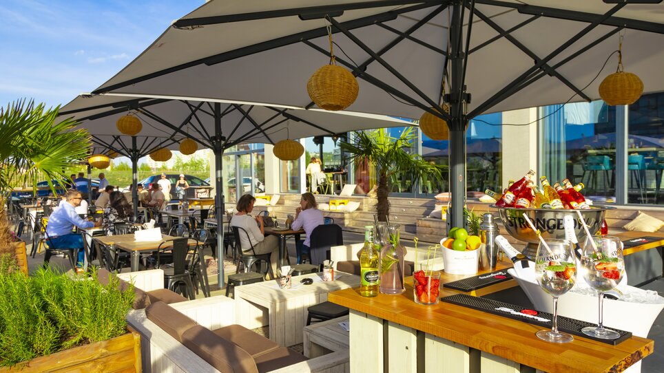 Cozy outdoor dining area with cocktails and guests.