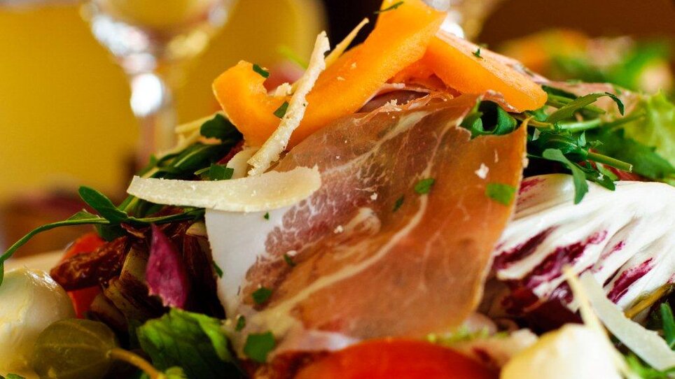 Salad with ham, vegetables, and dressing at Trattoria Siena. | © Trattoria Siena