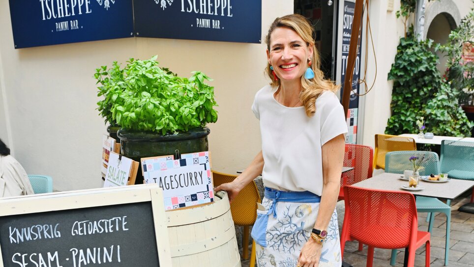 A smiling woman in a panini bar in Graz with fresh basil. | © Andrea Knura