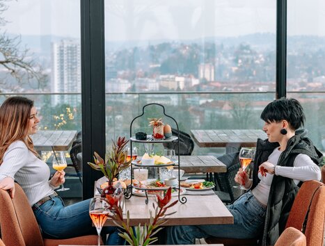 Zwei Frauen genießen Brunch und Cocktails bei aiola upstairs mit Blick auf Graz. | © 5komma5sinne - Rene Strasser Fotografie 