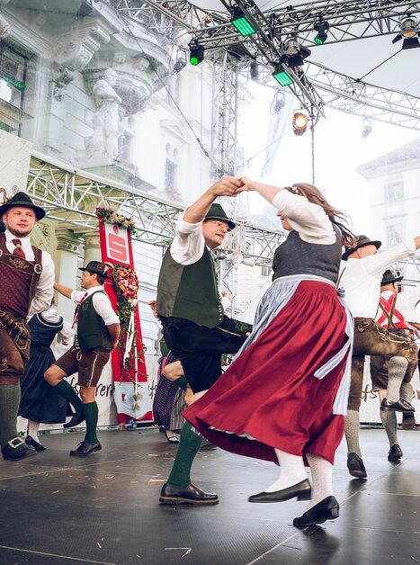 Group dancing in traditional costumes on stage. | © Ivents Kulturagentur