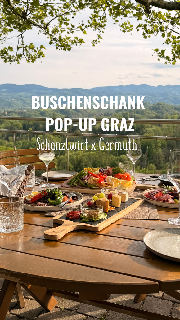 Table with food and drinks, view over Graz. | © Schanzlwirt