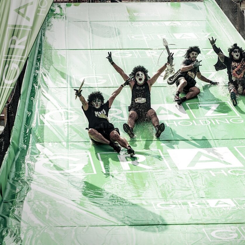 Crazy participants on a slide at the Grazathlon. Unique costumes and fun atmosphere. | © SportografCompanyCode