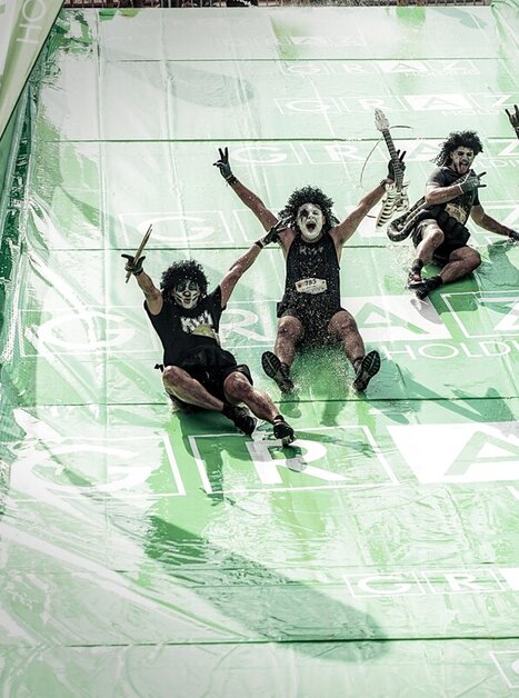 Crazy participants on a slide at the Grazathlon. Unique costumes and fun atmosphere. | © SportografCompanyCode