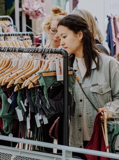 Due donne che sfogliano vestiti in un mercato a Graz. | © Kunst- und Designmarkt