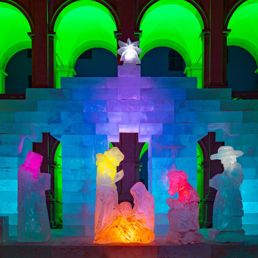 Presepe di ghiaccio con luci colorate nel cortile del Landhaus a Graz, figure di ghiaccio creano un'atmosfera festiva. | © Graz Tourismus - Harry Schiffer