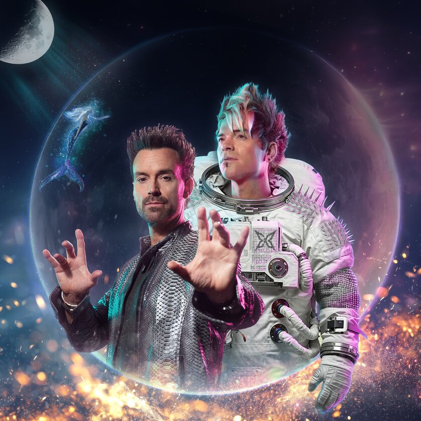 Two men in futuristic outfits, one as an astronaut, in space with a whale. | © Christian Bussel Seidel