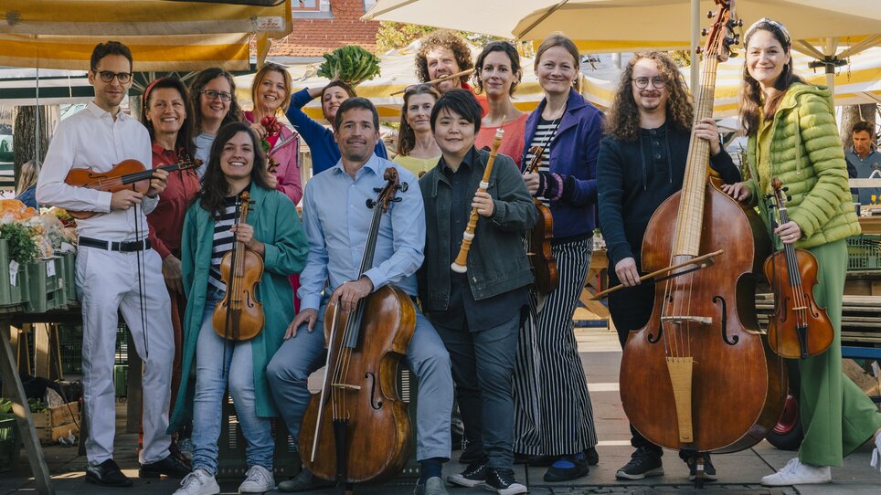 Ensemble posing with instruments outdoors. | © Madeleine Haider