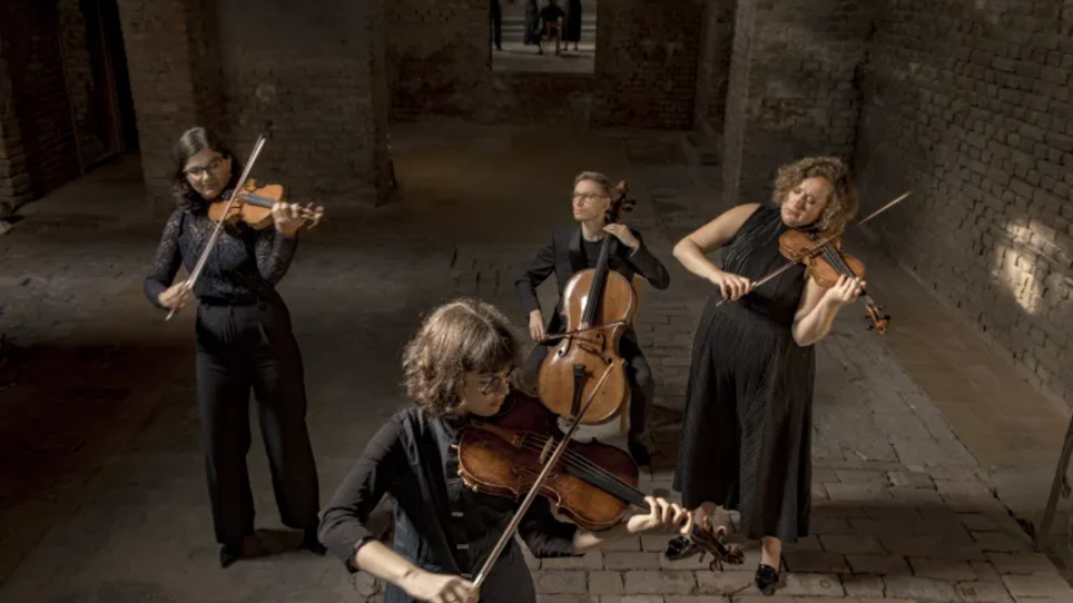 three women and an man are playing on strings in an old building  | © Davide Bertuccio