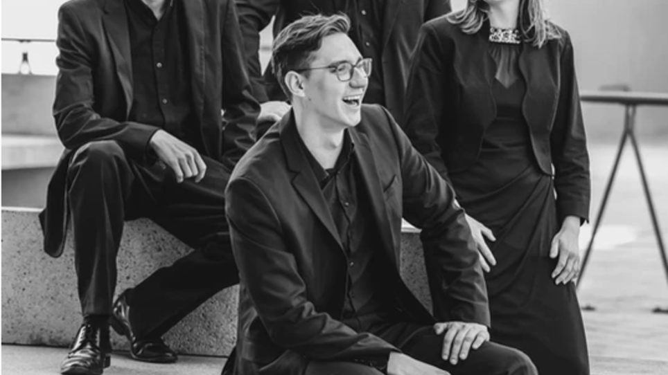 a photograph in black and white showing four young people in dark outfits | © Source Spectrum Quartet