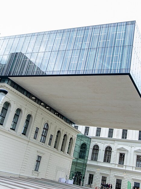 Floating glass structure over historic building design. | © Uni Graz - Kanizaj