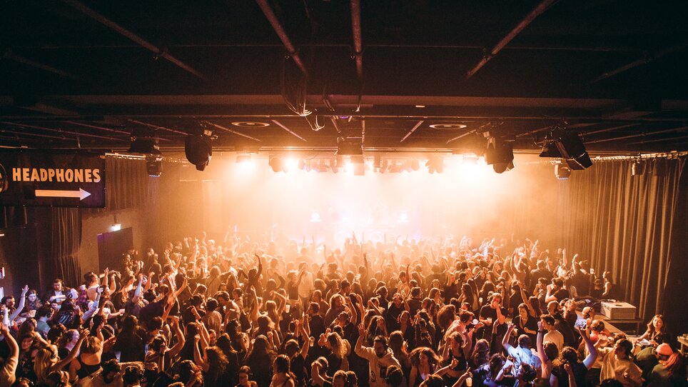 Eine große Menschenmenge feiert in einem beleuchtetem Club. | © Silent Disco Austria