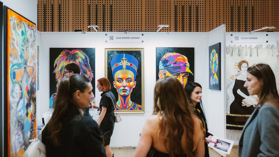 Visitors to Art Expo view colourful portraits. | © Katja Čemažar