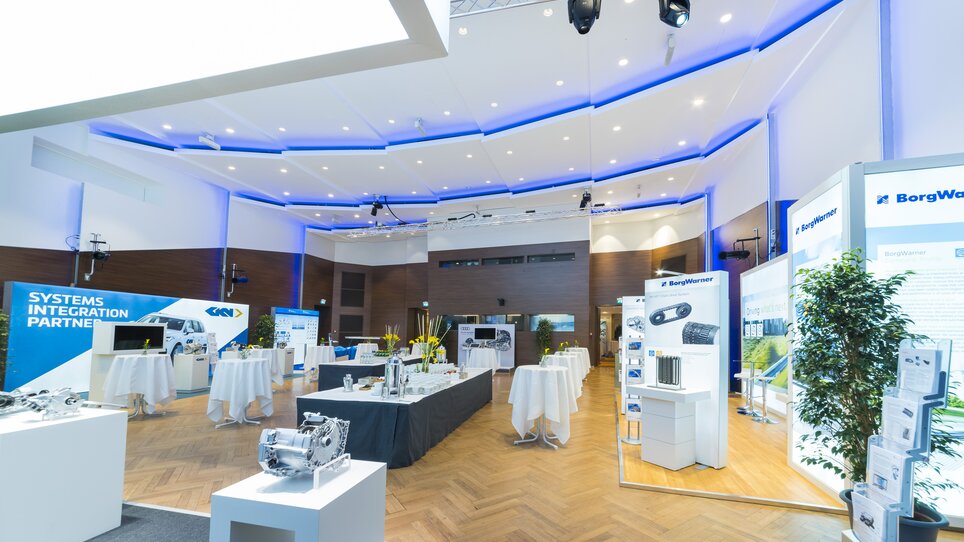 View of a modern conference venue with exhibition booths. | © MCG - Werner Krug