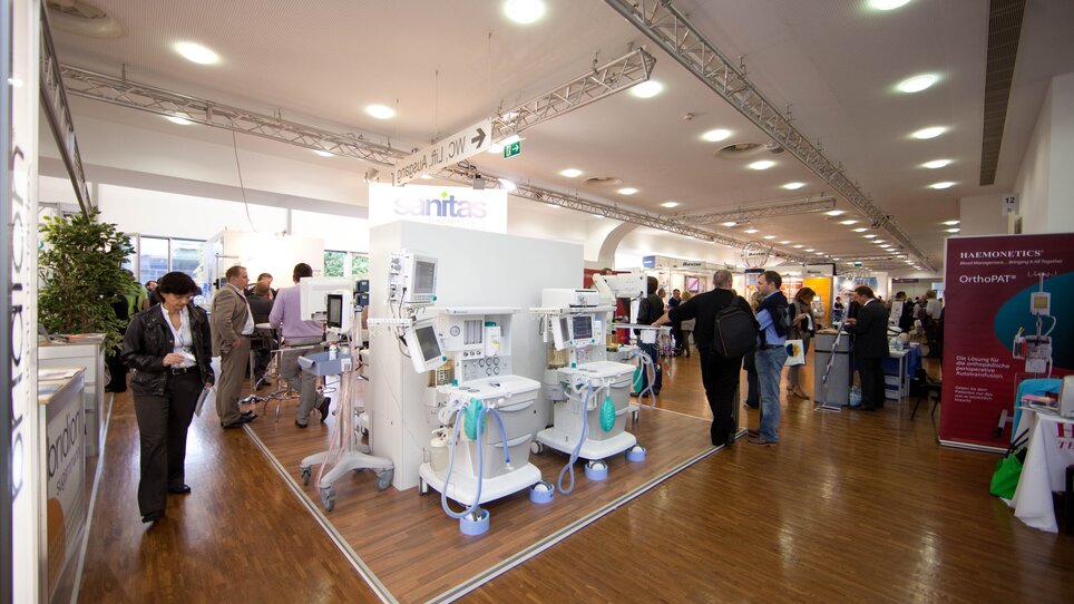 View of booths with medical equipment at a conference. | © MCG