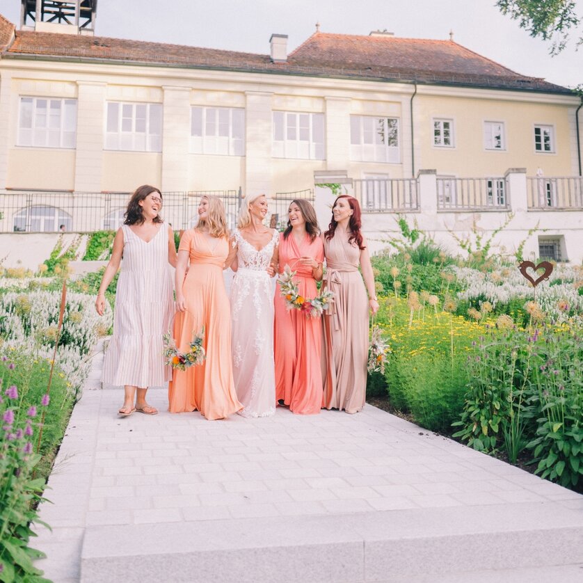 Schloss Vasoldsberg | © Pixellicious Fotografie Gruppenbild von Brautjungfern in pastellfarbenen Kleidern im Garten. | © Pixellicious Fotografie