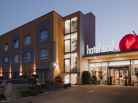 Exterior view of Hotel Süd with pink snail and support for business trips. | © Hotel Süd