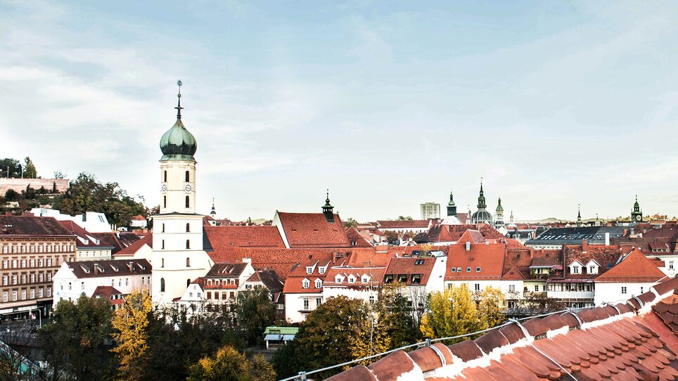 View of Graz featuring the Grazer Uhrturm and historic buildings from Hotel Das Weitzer. | © Florian Weitzer Hotels & Restaurants