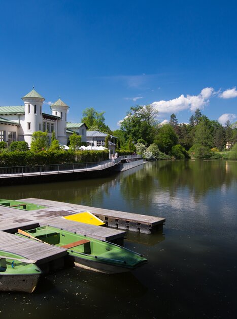 Beautiful view of Hilmteich in Graz with boat dock and lush greenery. | © Graz Tourismus - Harry Schiffer