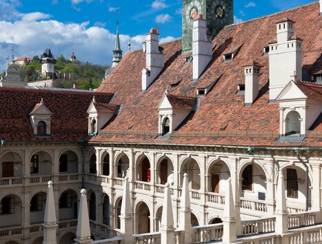 The Landhaus Courtyard in Graz with the Graz Clock Tower in the background. | © Graz Tourismus - Harry Schiffer