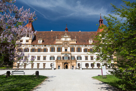 Das prächtige Schloss Eggenberg in Graz, umgeben von Blumen und Bäumen. | © Graz Tourismus - Harry Schiffer