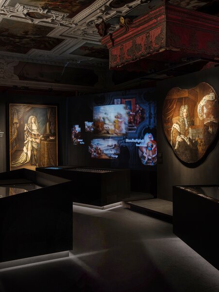 Dark exhibition space with artworks and digital projections. | © J. Luttikhuis - OPERA Amsterdam