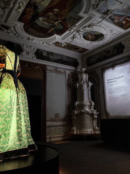 Illuminated dress in a historic room with projected shadows. | © J. Luttikhuis - OPERA Amsterdam