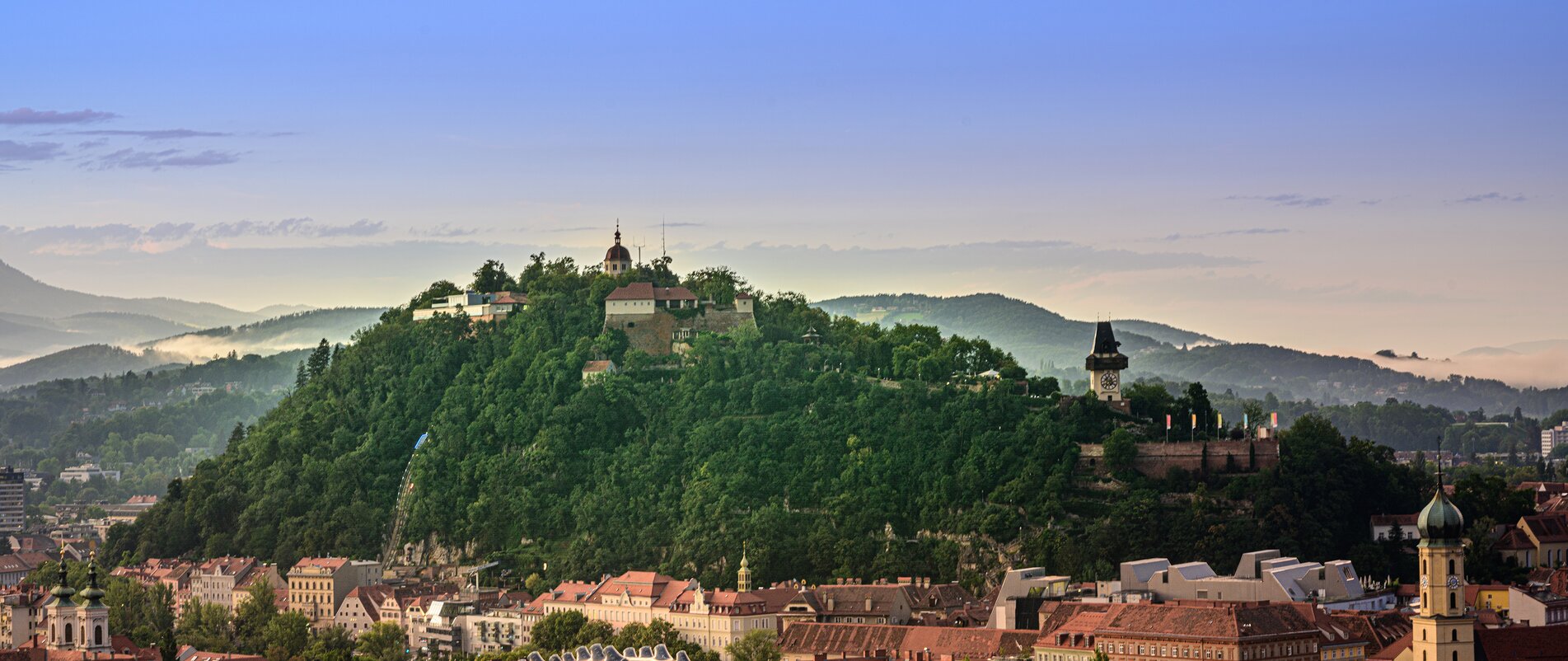 View of Graz with the Graz Clock Tower and Schlossberg in the background. | © Region Graz - pixelmaker