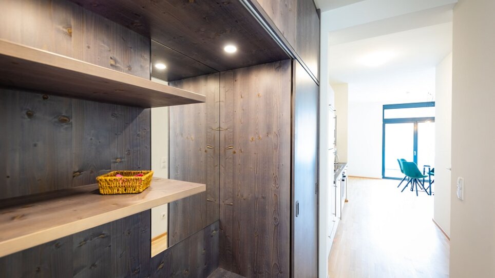 Geräumiger Flur mit Holzregalen und Beleuchtung