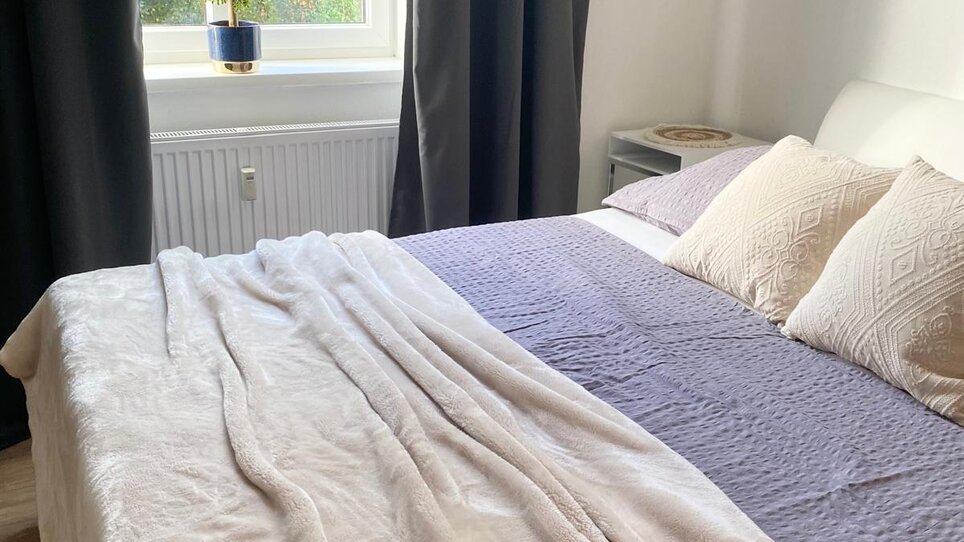 Bright bedroom with bed and window. | © CityStage Studio