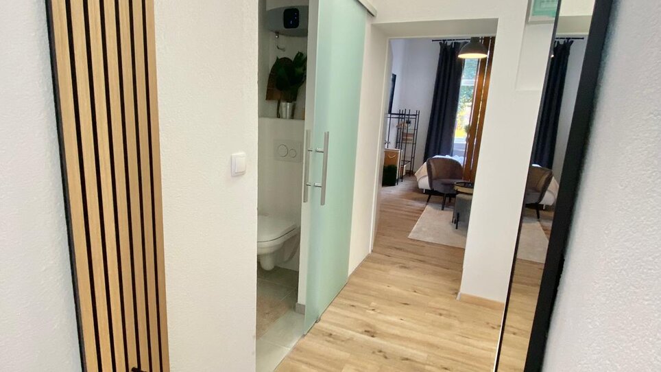 Modern hallway view with wooden flooring. | © CityStage Studio