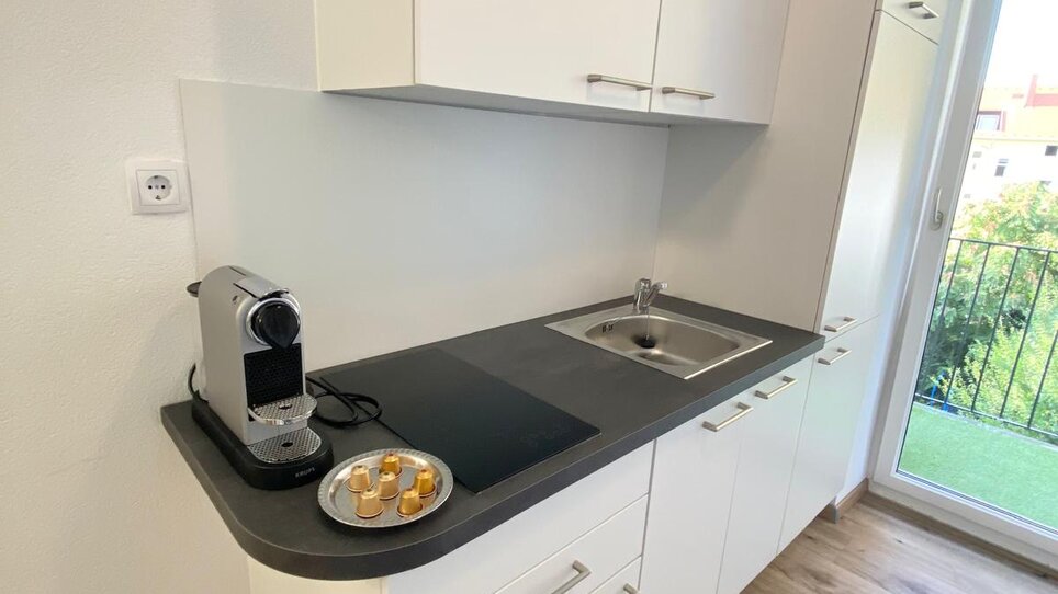 Modern kitchen with espresso machine. | © CityStage Studio
