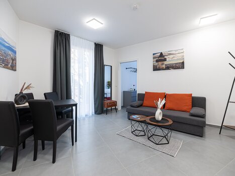 Grazora Living Suite with sofa, table and Graz clock tower picture. | © Grazora Living