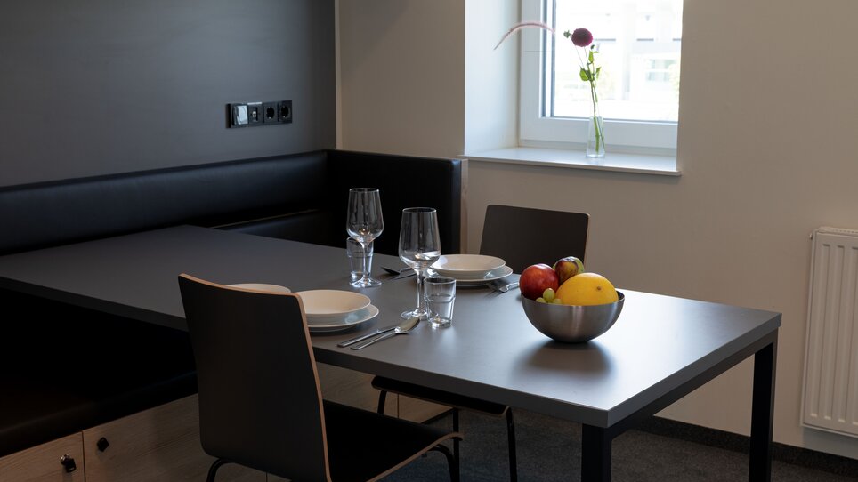 Tavolo con stoviglie e frutta in un appartamento moderno. | © Tomo-Tec Immo GmbH