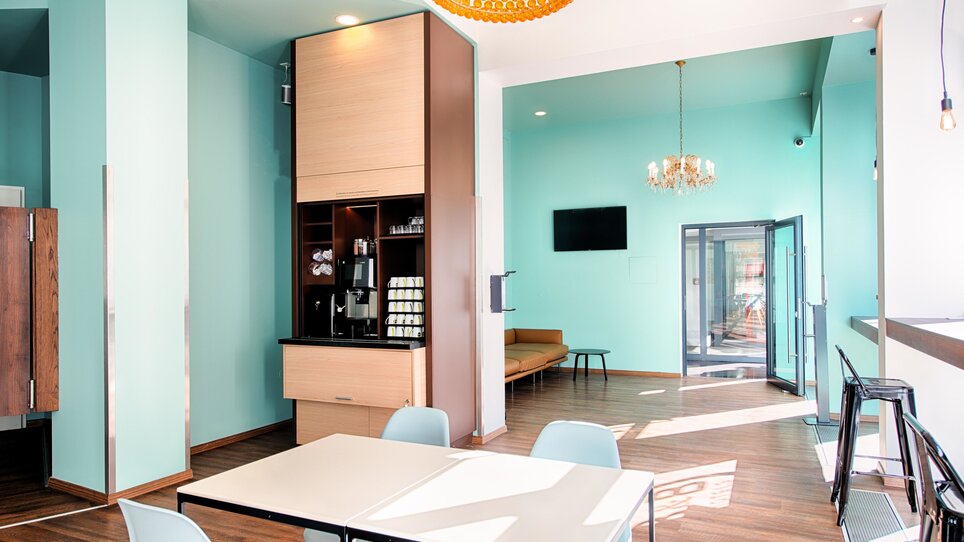 Innenbereich des B&B Hotels Graz mit Kaffeemaschine und gemütlichen Sitzbereichen. | © B&B Hotels 2023