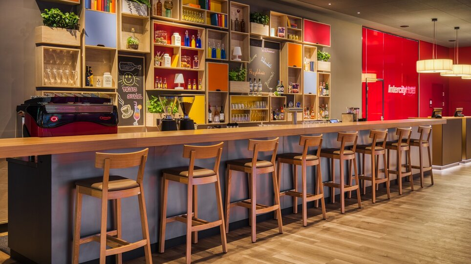 Moderne Bar mit unterschiedlichen Flaschen und offenen Regalen in einem stilvollen Ambiente. | © ICHG